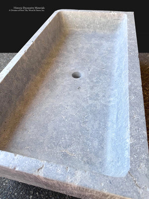 Large antiqued stone trough sink carved from French limestone