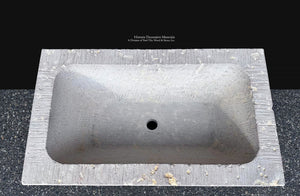 French stone basin with deep carved interior for statement powder room design