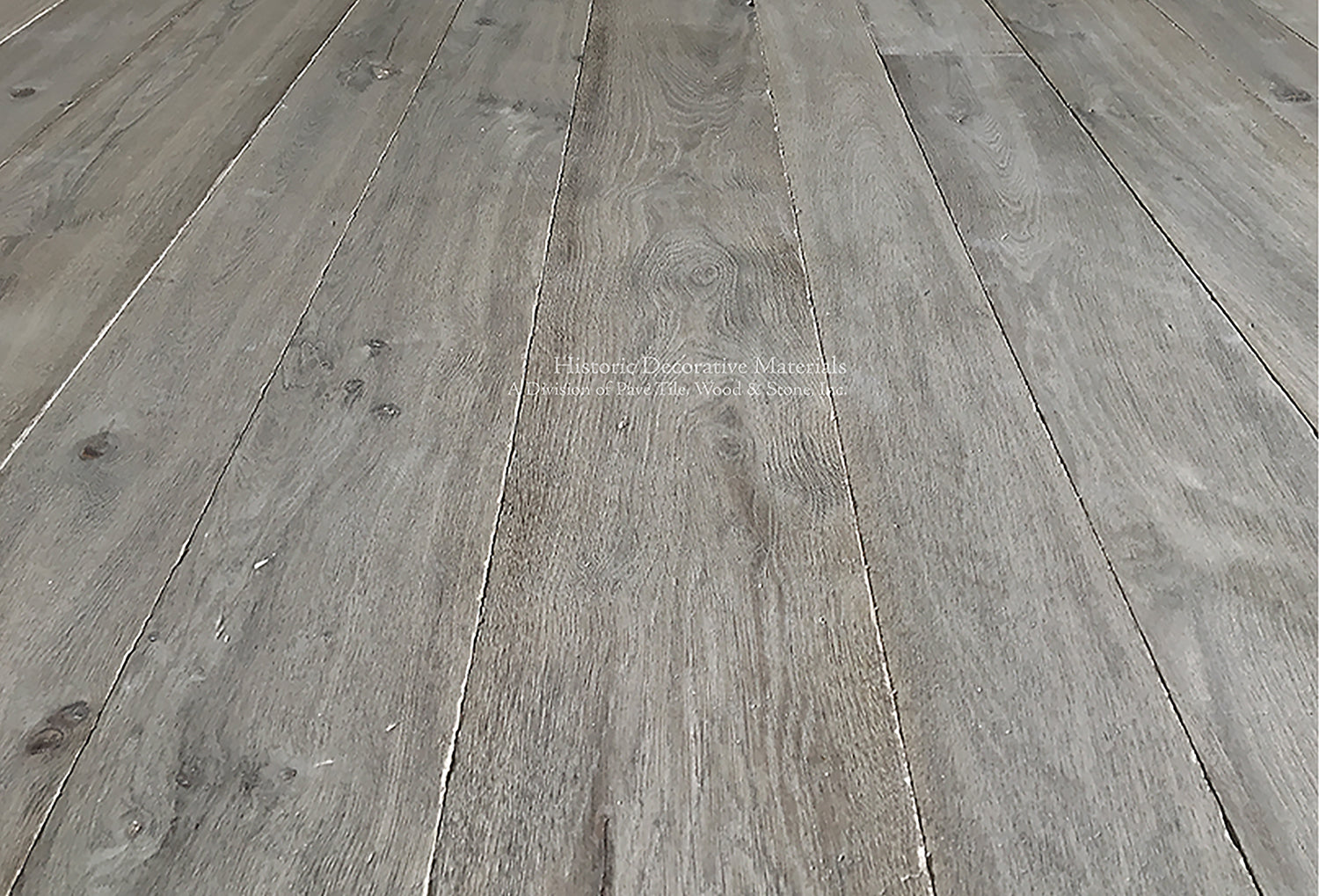 Reclaimed French Oak floors distressed by hand for a weathered gray hue is timeless.