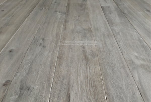 Reclaimed French Oak floors distressed by hand for a weathered gray hue is timeless.