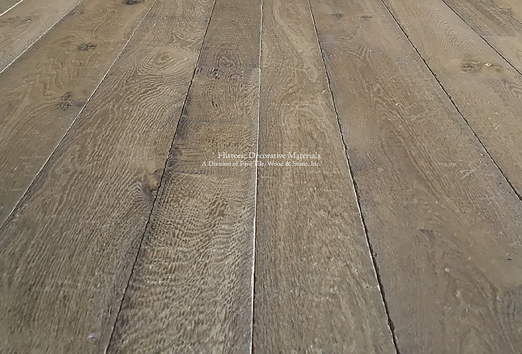 Antiqued French oak flooring hand-milled and pre-finished in a vintage oak color is 18th century revival.