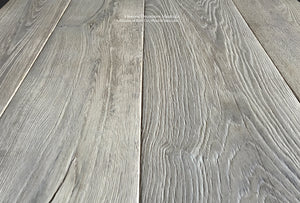 Gray antiqued French oak floors are highly brushed that reveal a sublime patina.