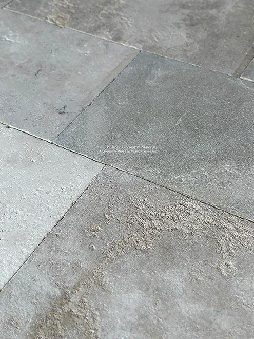 Unique color range of soft gray blue and beige of antique French limestone flooring for elegant kitchens and baths.