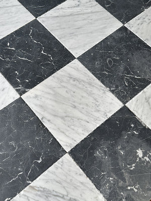 old world black and white checkerboard tile with layered patina