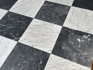 old world black and white checkerboard tile with layered patina