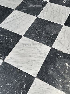 timeworn black and white checkerboard stone floor pattern