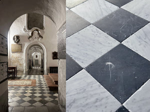 black and white antiqued checkerboard marble floor in old world architectural castle
