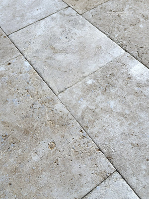 French limestone flooring entry hall with warm neutral antique tones