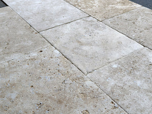 Antiqued French limestone kitchen floor inspired by Burgundy stone traditions