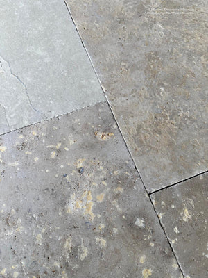Antiqued limestone tiles replicating the floors of historic French monasteries
