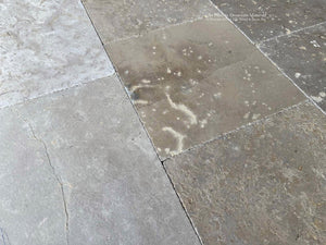 Antiqued French limestone flooring inspired by historic abbey floors of Provence