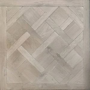 Antiqued French Parquet de Versailles Oak floors in a white patina makes for a refined dining room floor.