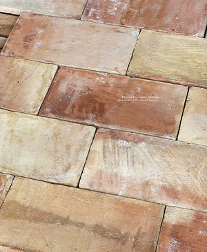 Installing French reclaimed terra cotta tile pareuille in the off-set joint pattern adds interest to a kitchen floor.