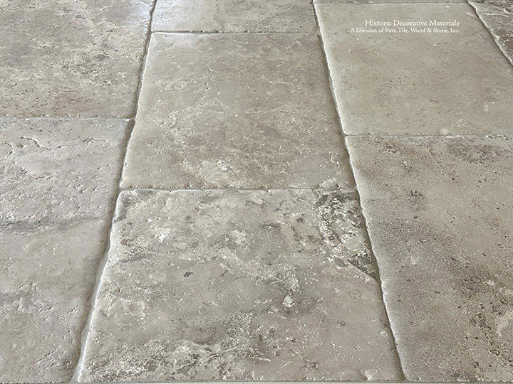 Antiqued French Limestone Flooring installed in primary bedrooms reveal an elegant beauty.