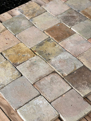 Antique French terra cotta tile cobblestones have a patina that resembles a 12th century medieval floor. 