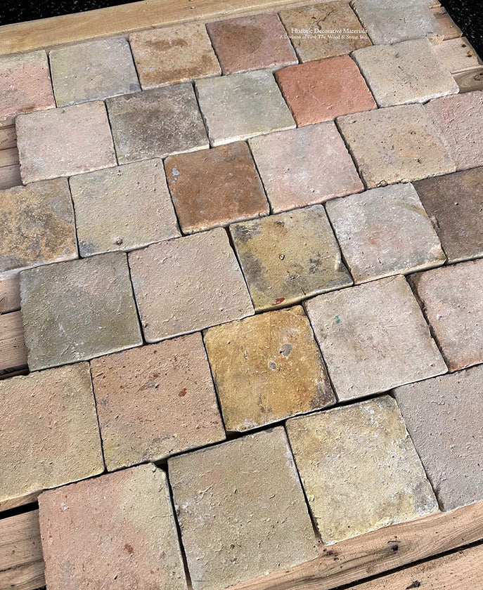 An off-set joint installation for this antique French reclaimed terra cotta tile cobblestone makes it more authentic for a kitchen floor.