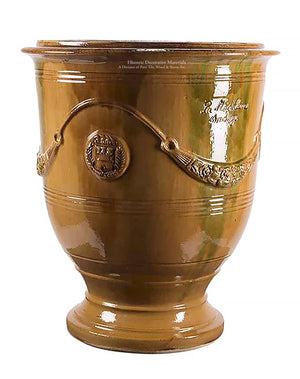 Vintage French pottery with an ochre earth tone glaze will heighten beauty of garden decor.