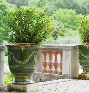 The weathered green patina of this Anduze terra cotta vase elevates Provençal gardens.