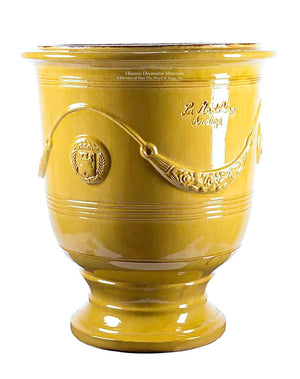 Artisanal decorative vase from Anduze, France shines in a Provençal yellow hue that glorifies decorative gardens.