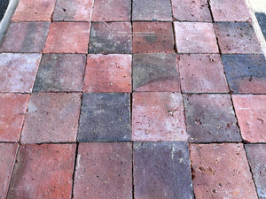 Antique French terra cotta tiles with naturally aged red and charcoal surfaces
