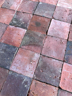 Reclaimed French terra cotta flooring with soft rose, brick red and brown patina