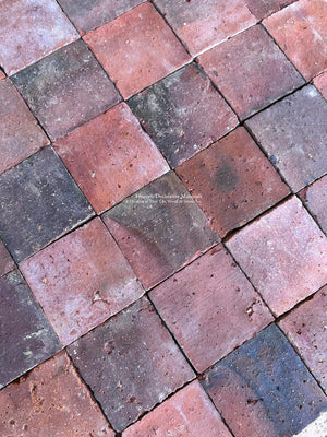 Antique French terra cotta tile with authentic surface wear and faded red tones