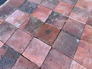 Reclaimed French terra cotta flooring with aged surface texture and dark firing variation