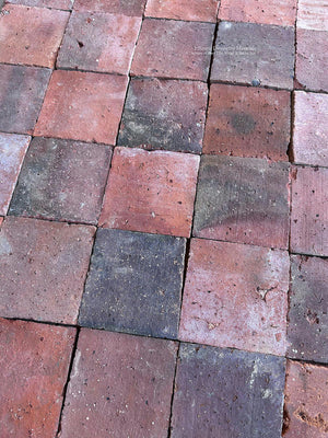 Reclaimed French terra cotta flooring with weathered surface and smoky charcoal tones