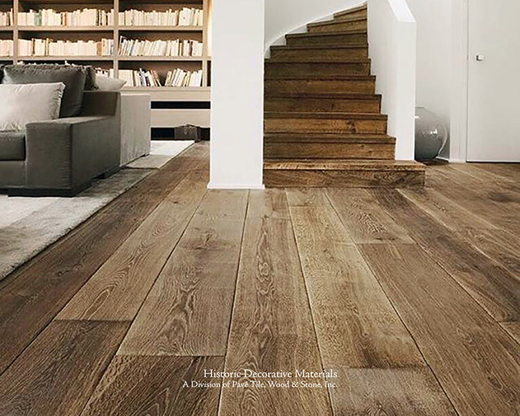 Custom stair treads and wide-planks are a hallmark of our antiqued French oak floors.
