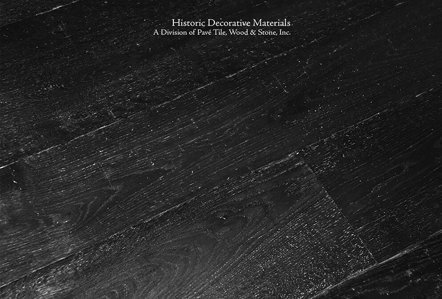 Olde Black antiqued French oak flooring softens contemporary lines of high ceilings and white walls.