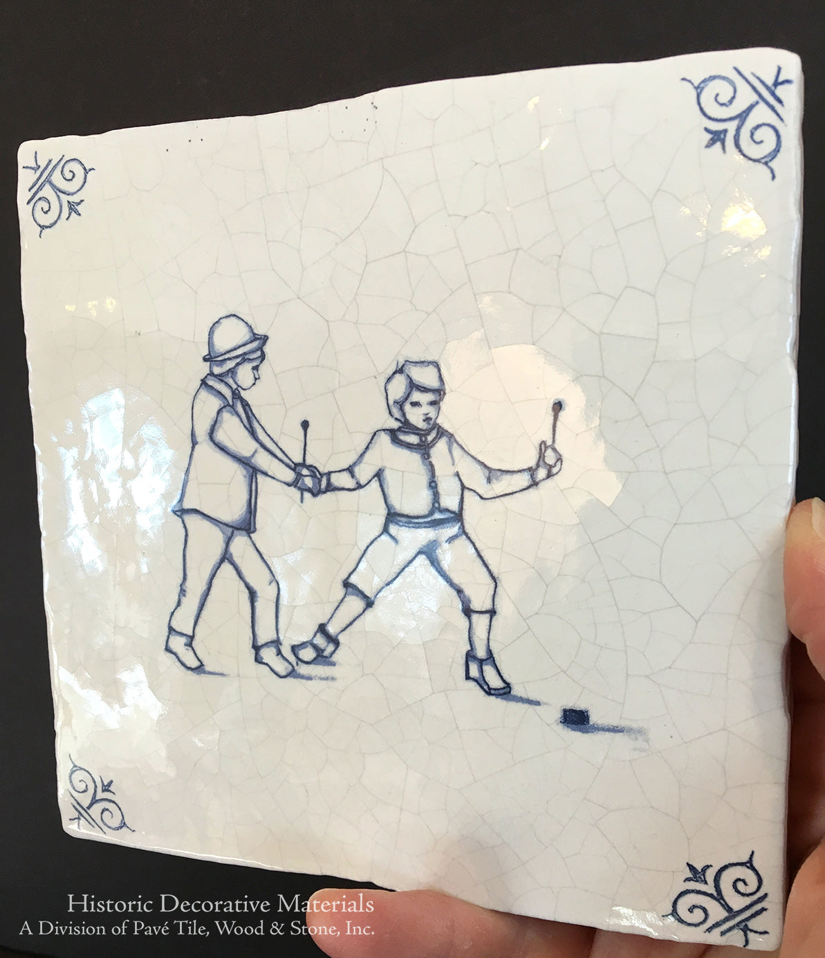 Hand painted Delft tile of children playing hockey motif is joyful.